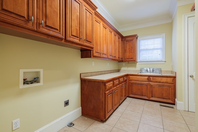laundry room featuring washer hookup, cabinet space, ornamental molding, a sink, and electric dryer hookup
