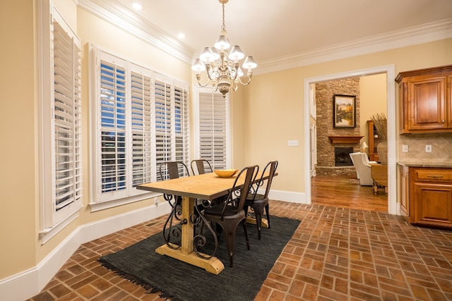 dining area featuring ornamental molding, brick floor, a fireplace, and baseboards