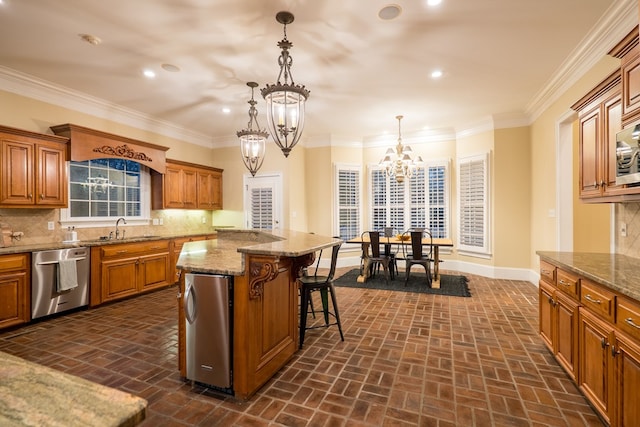 kitchen with dishwasher, a breakfast bar, a center island, pendant lighting, and a sink