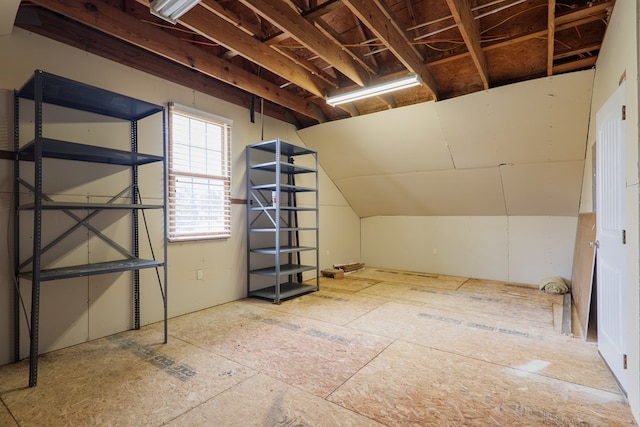additional living space featuring lofted ceiling