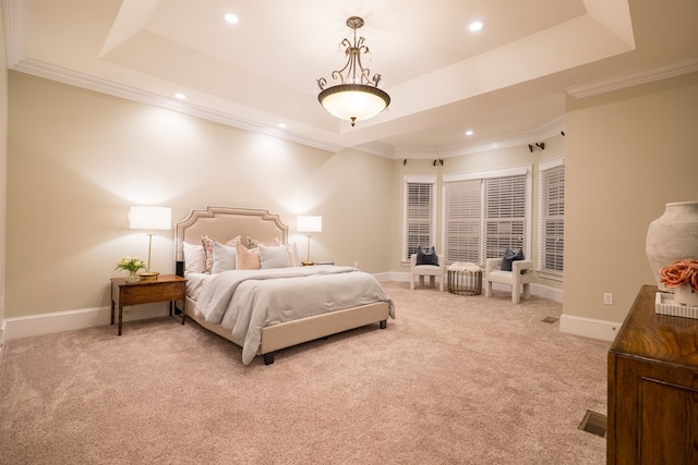bedroom with light carpet, baseboards, a tray ceiling, and crown molding
