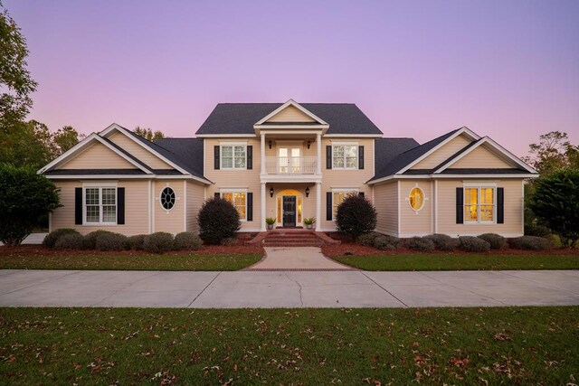 greek revival house with a front yard