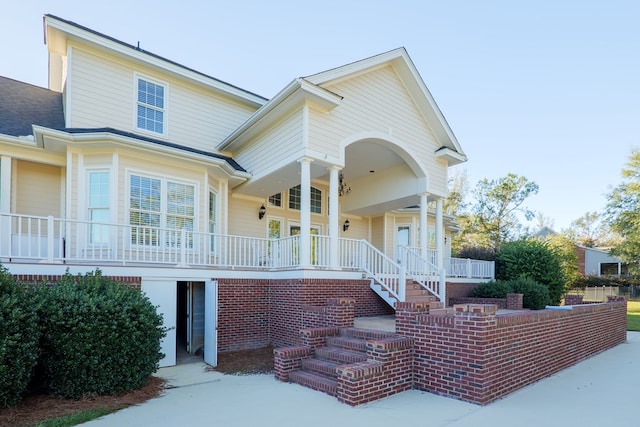 view of front of house with covered porch and stairway