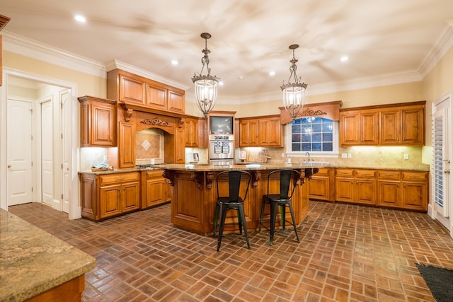 kitchen featuring brown cabinetry, a kitchen island, and pendant lighting