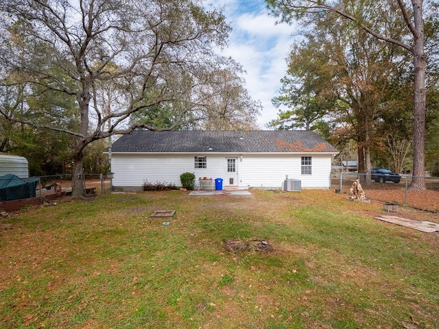 rear view of house with a yard, central AC, and a patio area