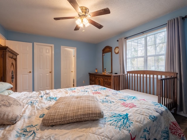 bedroom featuring a textured ceiling and ceiling fan