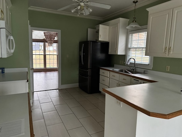 kitchen with kitchen peninsula, sink, white cabinets, and hanging light fixtures