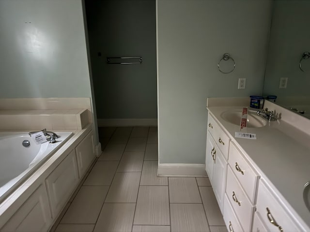 bathroom with a tub and vanity