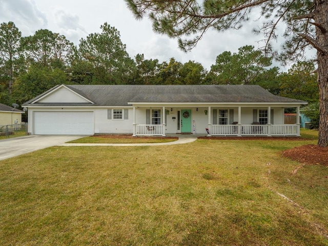 ranch-style house with covered porch, a garage, and a front yard