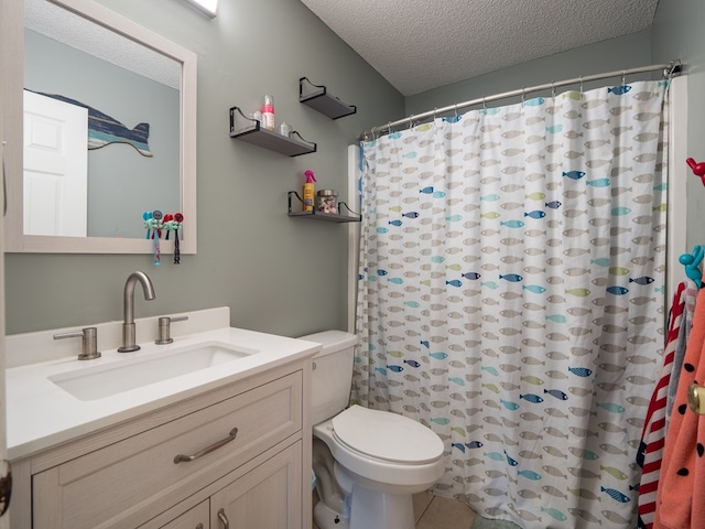 bathroom featuring a shower with curtain, vanity, a textured ceiling, tile patterned flooring, and toilet