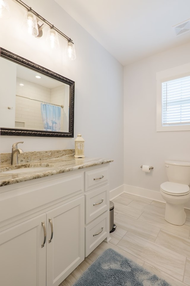 3024 Mary Powell Way, Hahira, GA 31632 - full bathroom featuring toilet, vanity, baseboards, and a shower with curtain
