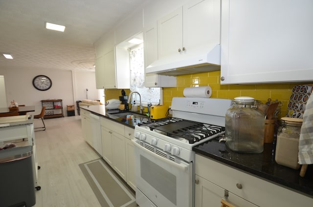 kitchen featuring sink, white cabinetry, light hardwood / wood-style flooring, white appliances, and backsplash