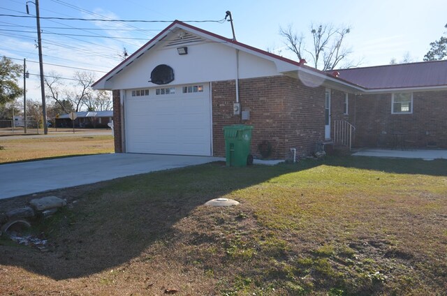 view of side of property with a garage, an outdoor structure, and a lawn