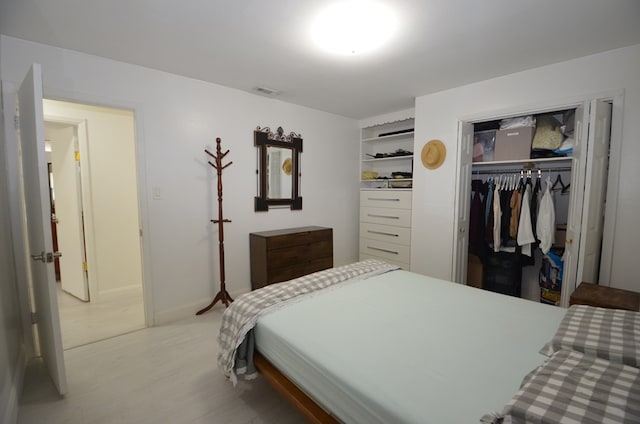 bedroom featuring light hardwood / wood-style floors and a closet