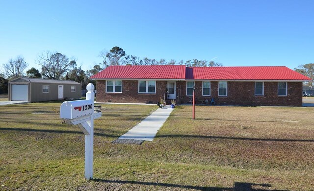 single story home with a garage, an outdoor structure, and a front yard