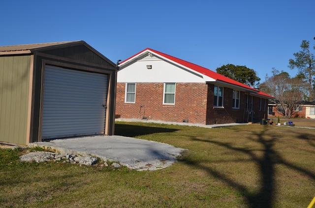 view of side of home featuring a garage, an outdoor structure, and a yard