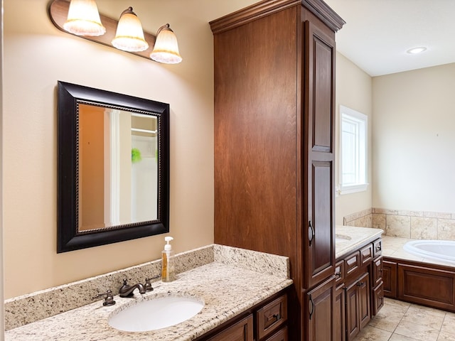 full bathroom featuring tile patterned flooring, a bath, and vanity