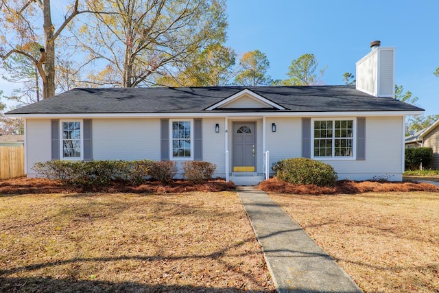 ranch-style home with a front lawn