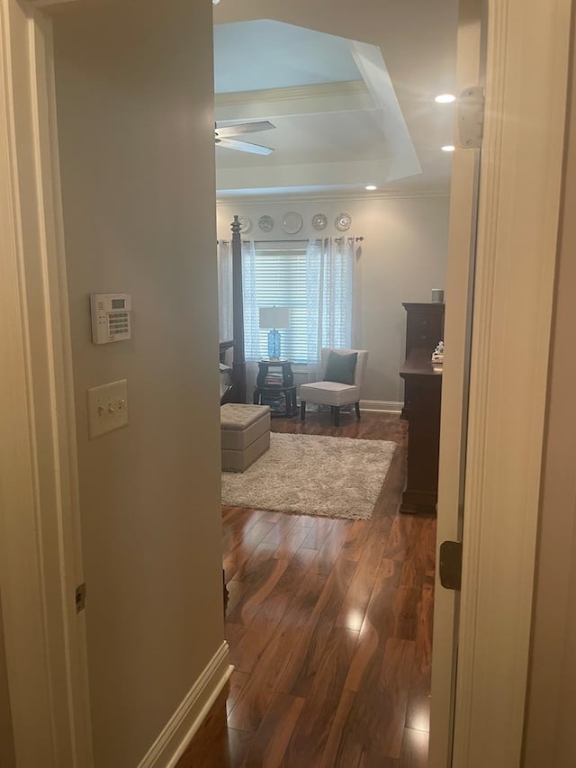 hall featuring baseboards and wood finished floors