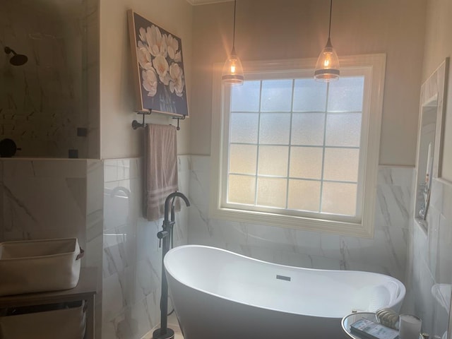 full bath with a soaking tub, tile walls, and wainscoting