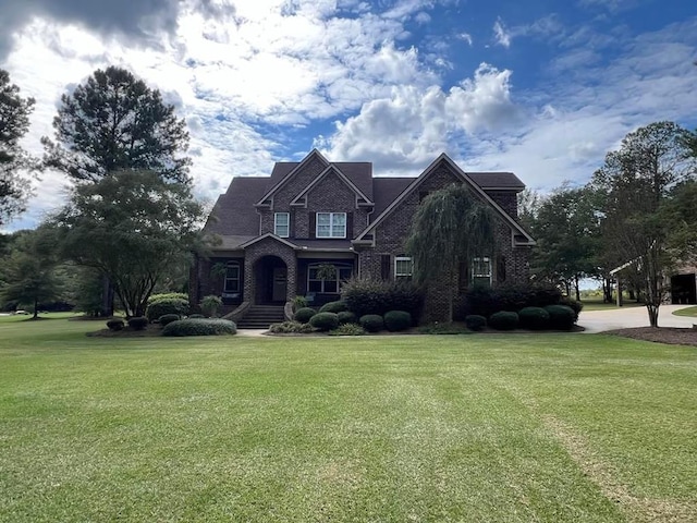 view of front of house with a front lawn and brick siding