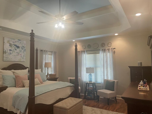 bedroom with ornamental molding, recessed lighting, a raised ceiling, a ceiling fan, and dark wood-style flooring