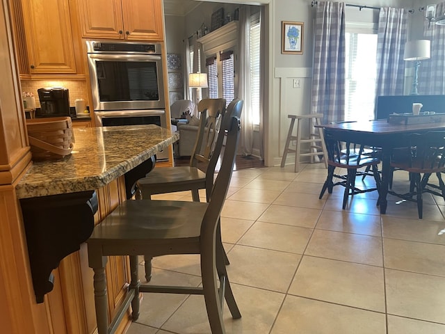 dining space featuring light tile patterned floors