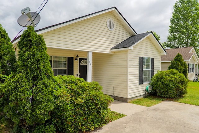 bungalow-style house featuring a porch and a shingled roof