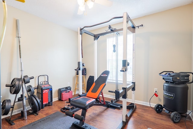 workout area with baseboards, a ceiling fan, and wood finished floors