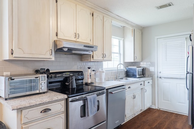 kitchen with visible vents, appliances with stainless steel finishes, a toaster, a sink, and under cabinet range hood