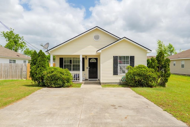 bungalow-style house with a porch, fence, and a front yard