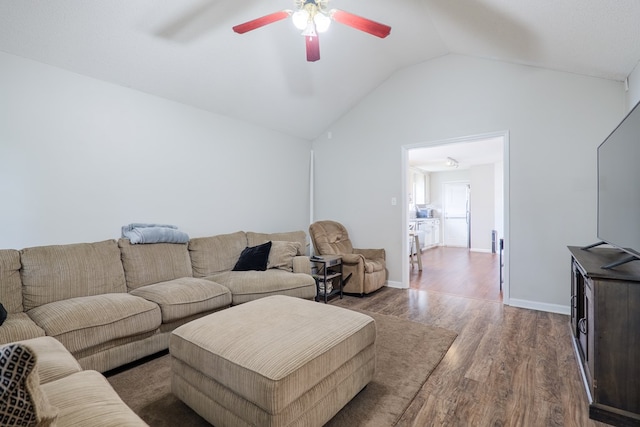 living area featuring baseboards, ceiling fan, wood finished floors, and lofted ceiling
