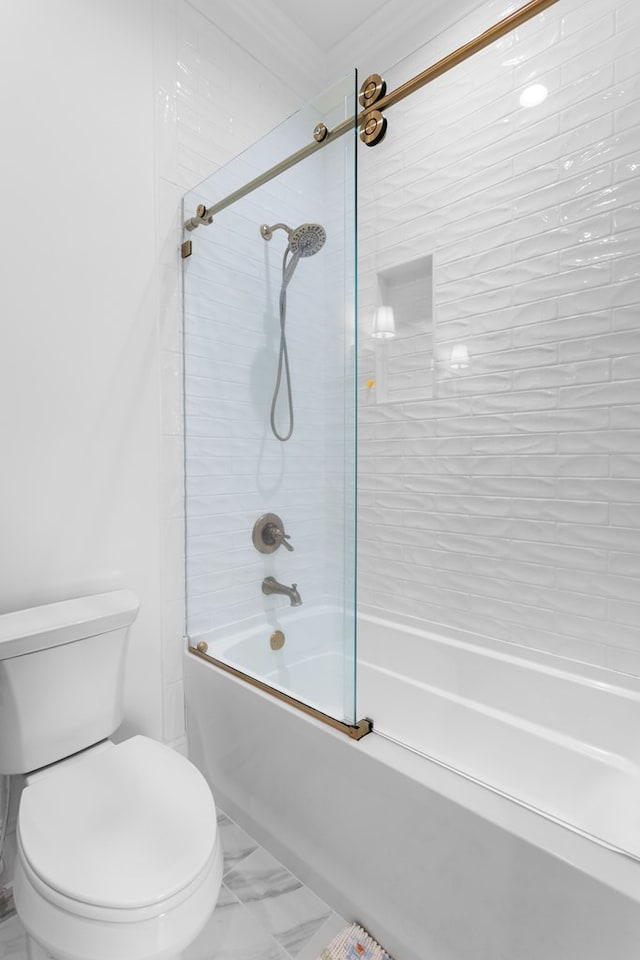 bathroom with marble finish floor, toilet, and bath / shower combo with glass door