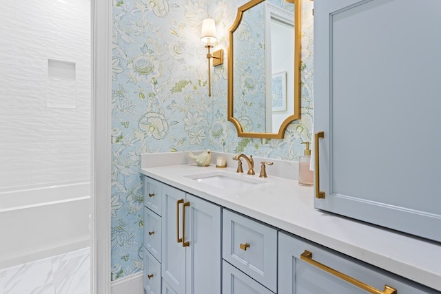 full bathroom with vanity and wallpapered walls