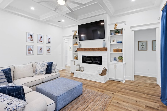 living area with light wood finished floors, beam ceiling, a ceiling fan, and crown molding