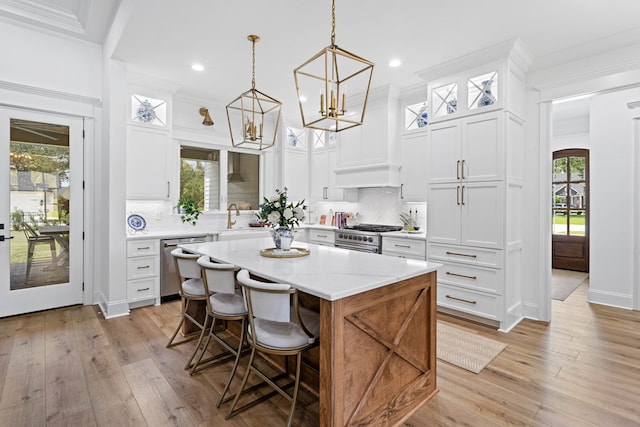 kitchen with tasteful backsplash, glass insert cabinets, a center island, and stainless steel appliances