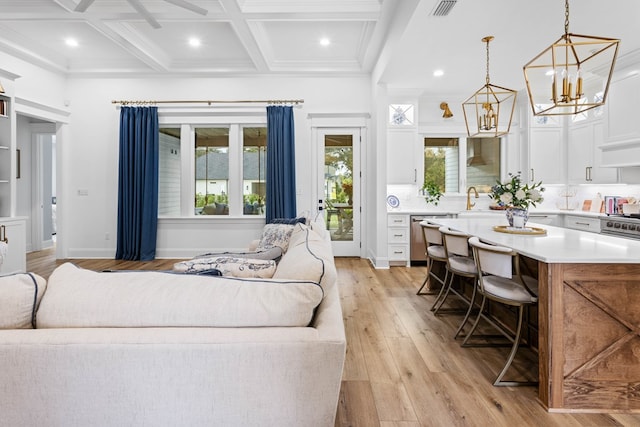 living area featuring recessed lighting, a chandelier, visible vents, and a healthy amount of sunlight