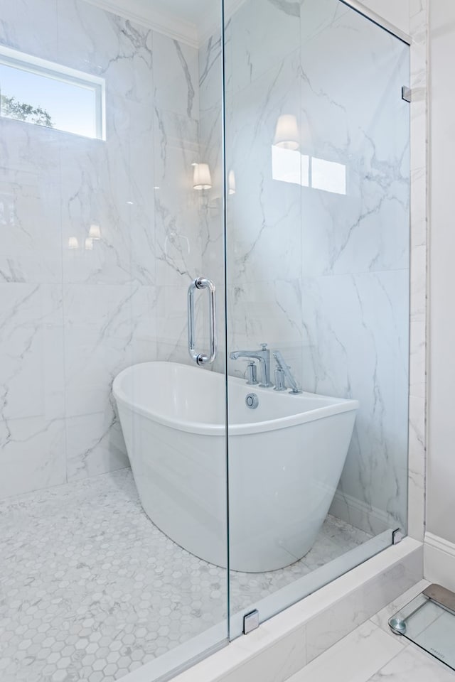 full bathroom featuring a shower stall, marble finish floor, and a freestanding bath