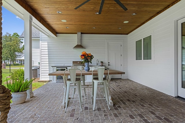 view of patio / terrace with fence, ceiling fan, and outdoor dining space
