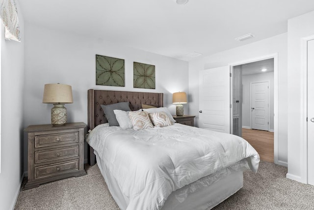 carpeted bedroom with visible vents and baseboards