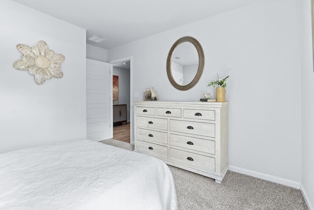 bedroom featuring visible vents, baseboards, and light colored carpet