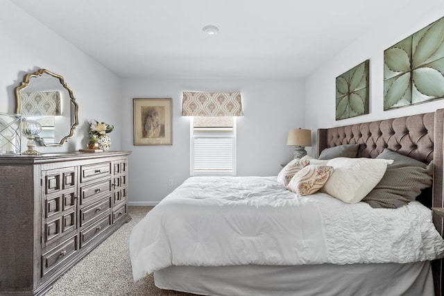 carpeted bedroom featuring baseboards