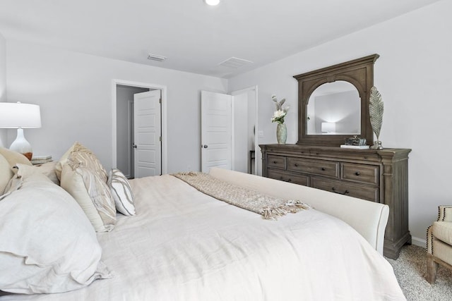 carpeted bedroom featuring visible vents and baseboards