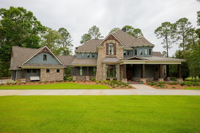 view of front of property with covered porch and a front yard