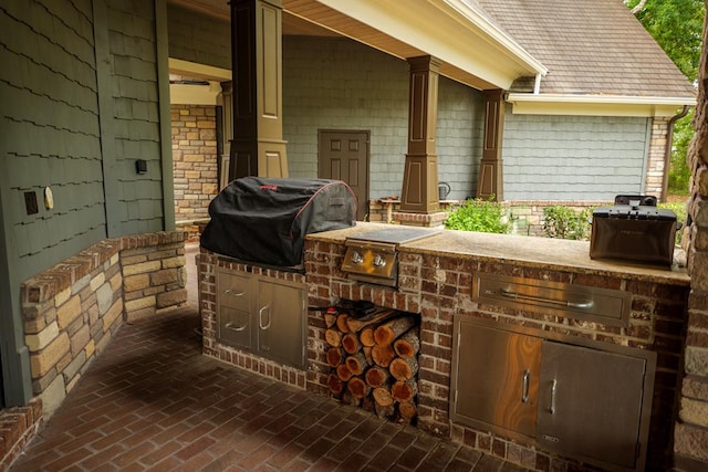 view of patio with an outdoor kitchen and area for grilling