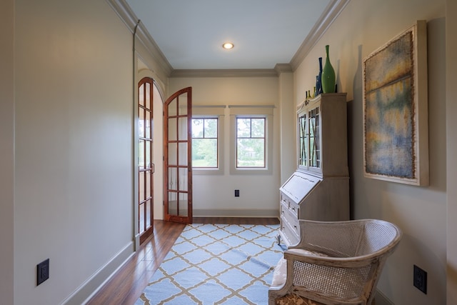 unfurnished room featuring french doors, hardwood / wood-style flooring, and crown molding