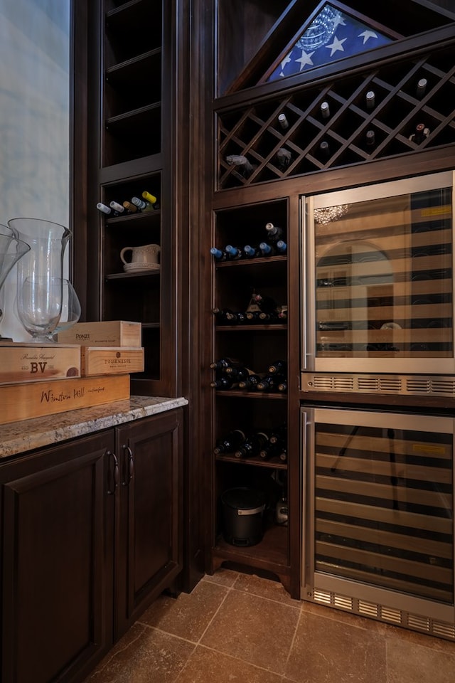 wine area with tile patterned floors and beverage cooler