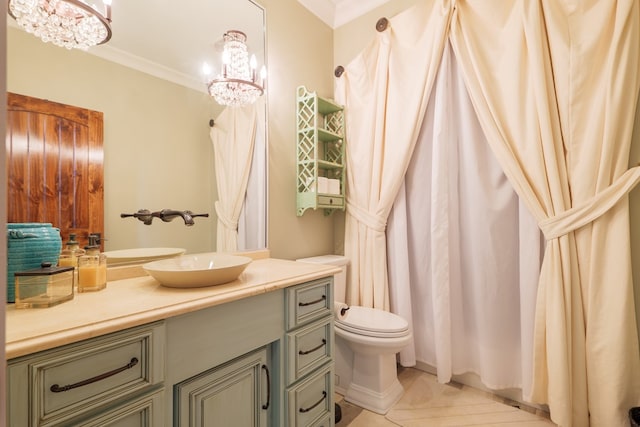 bathroom featuring tile patterned flooring, vanity, crown molding, and an inviting chandelier