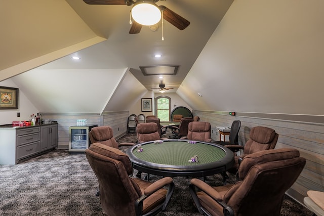 recreation room featuring carpet, wood walls, and vaulted ceiling