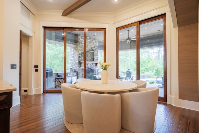 dining room with beamed ceiling, dark hardwood / wood-style floors, ceiling fan, and crown molding